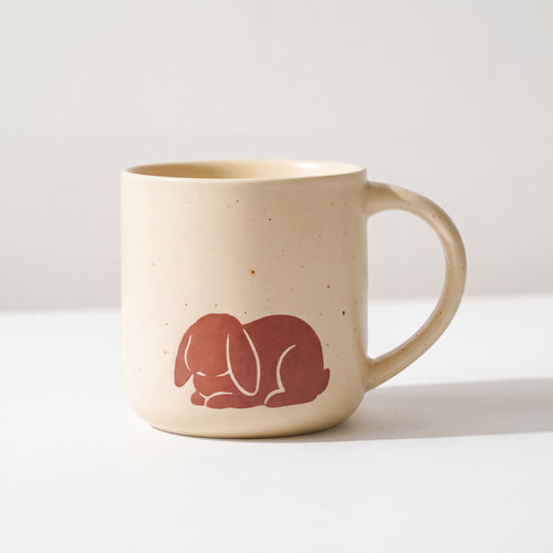 ROOT24STUDIO The Bunny Mug featuring raised terracotta sleeping lop-eared rabbit relief on speckled ceramic