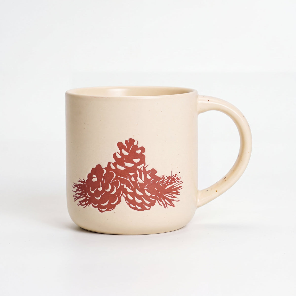 ROOT24STUDIO The Pinecone Mug featuring raised terracotta pinecone motif on speckled off-white stoneware