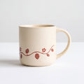 ROOT24STUDIO The Wild Strawberry Mug featuring panoramic terracotta berry vine relief on speckled ceramic