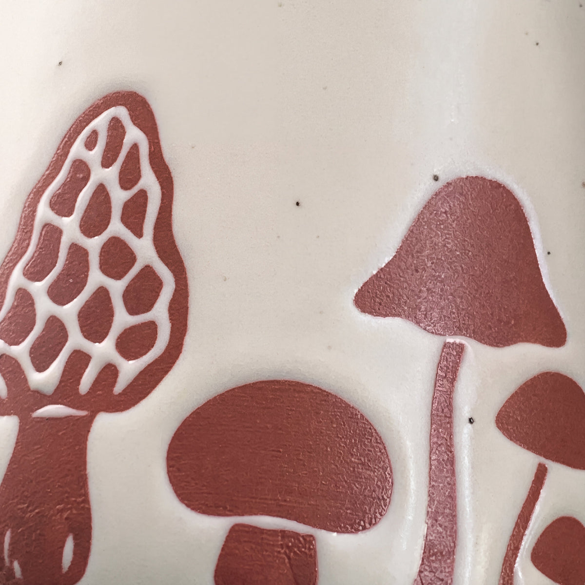 Macro detail of raised honeycomb morel mushroom motif and natural ceramic iron speckles