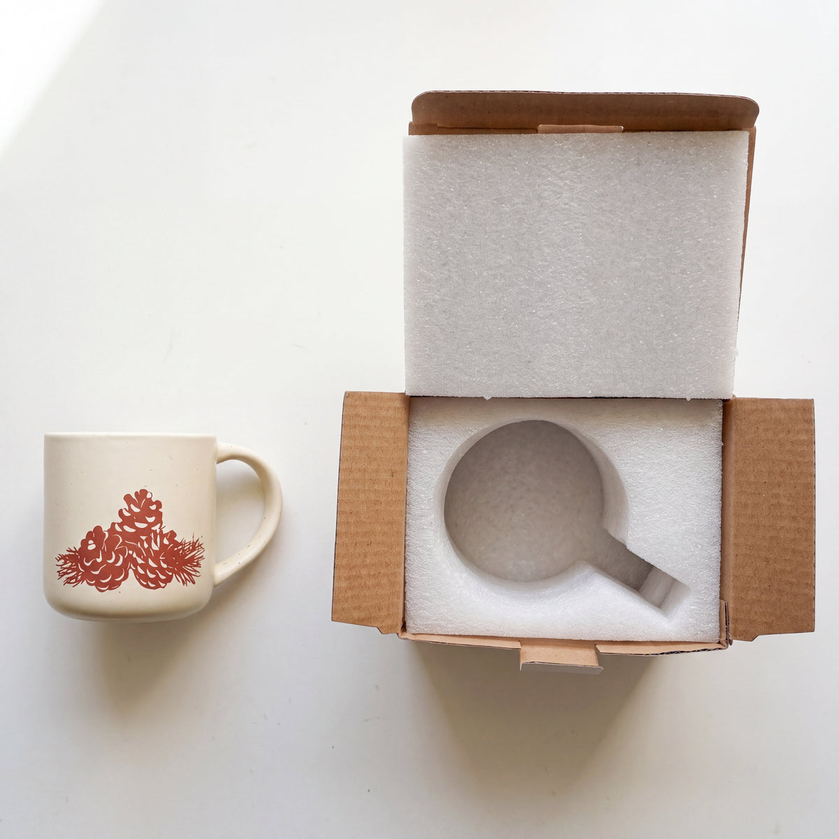Custom shock-absorbing white foam packaging and gift-ready box for The Pinecone Stoneware Mug