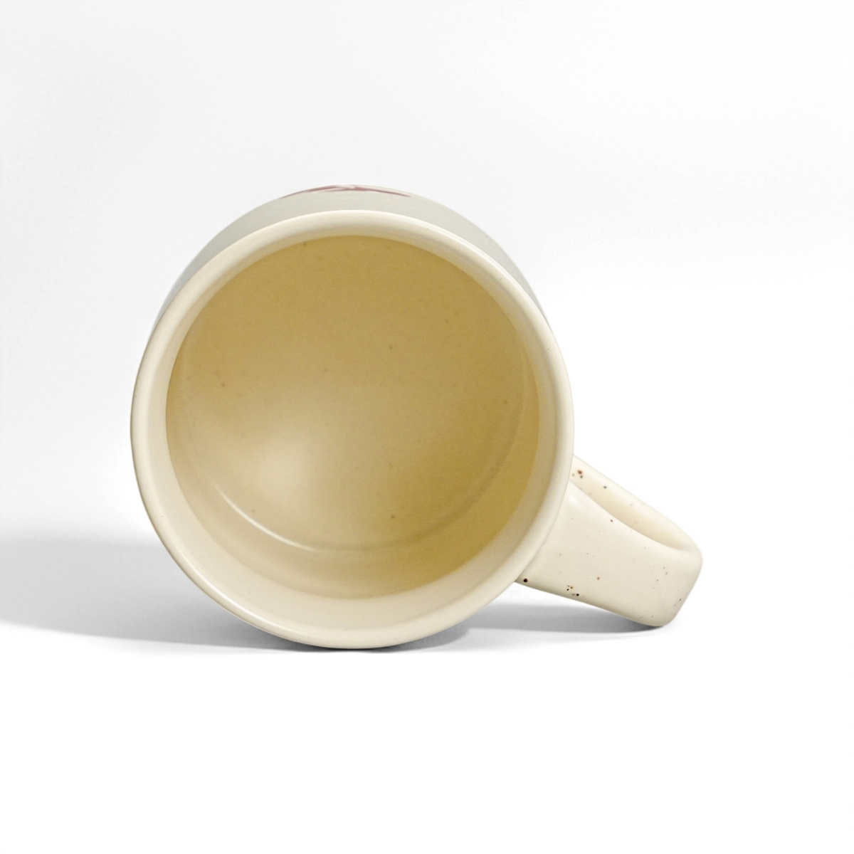 Top interior view of 12oz ceramic coffee mug showing smooth food-safe speckled vanilla glaze