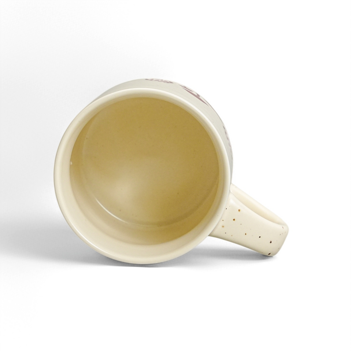 Top interior view of 12oz ceramic coffee mug showing glossy food-safe vanilla glaze and handle