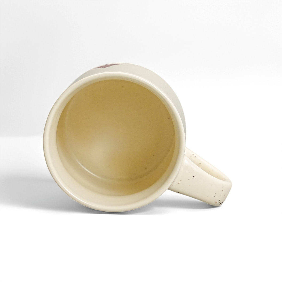 Interior view of ROOT24STUDIO 12oz stoneware mug showing smooth food-safe speckled vanilla ice glaze