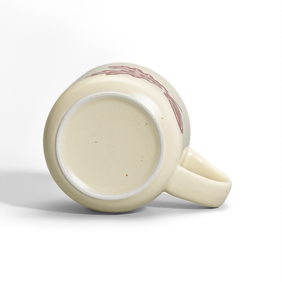 Unglazed raw stoneware foot ring and smooth ceramic base of The Acorn Mug