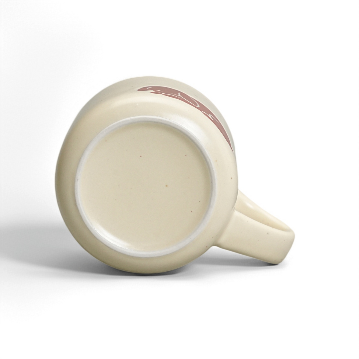 Unglazed raw stoneware foot ring and smooth ceramic base of The Bunny Mug