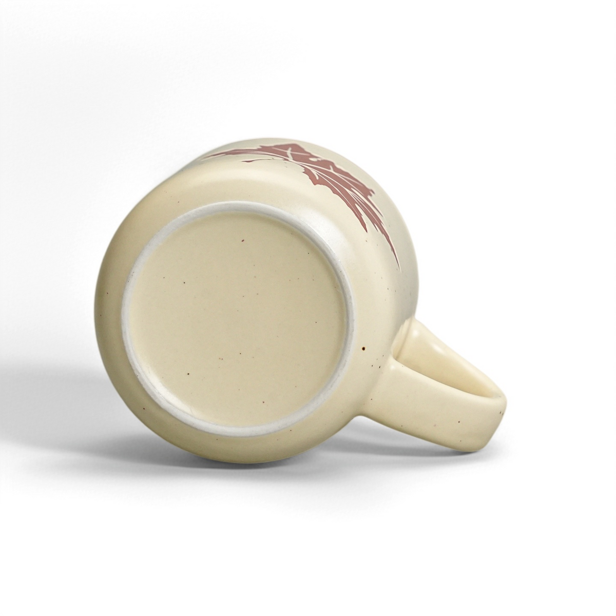 Unglazed raw stoneware foot ring and smooth ceramic base of The Maple Mug